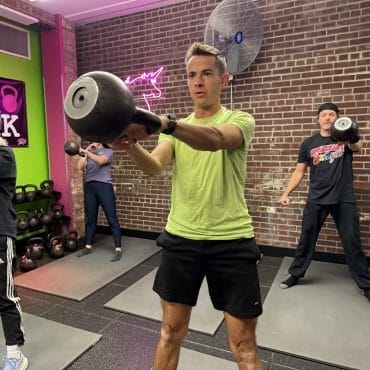 Mans with kettlebells at Speakeasy of Strength