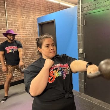 Woman boxing with kettlebell at Speakeasy of Strength